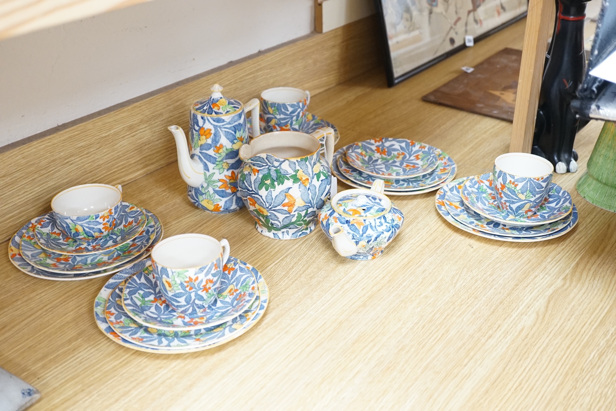 From the Studio of Fred Cuming. A Rainbow pottery tea set including sandwich plates, trios and coffee pot. Condition - varies, mostly fair